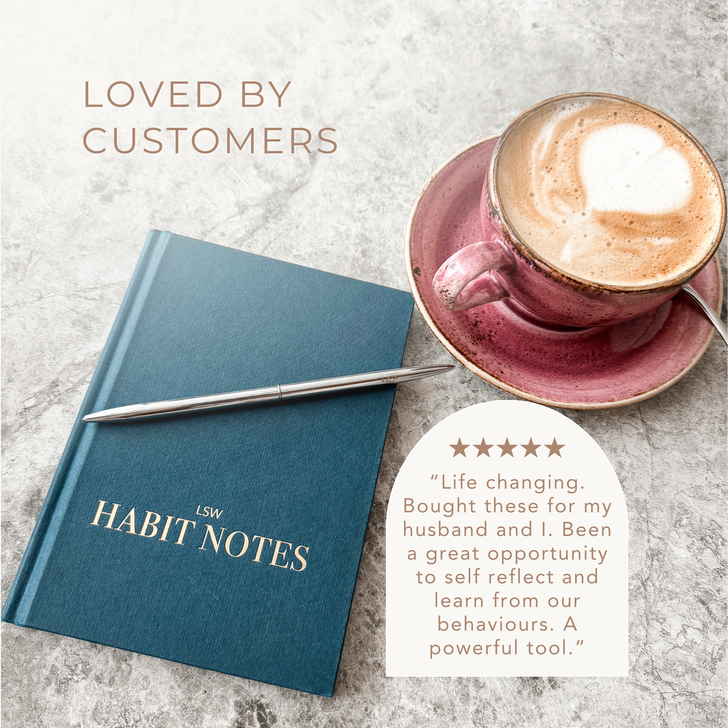 Blue notebook with a pen and a cup of coffee on a marble surface, with a customer review displayed.