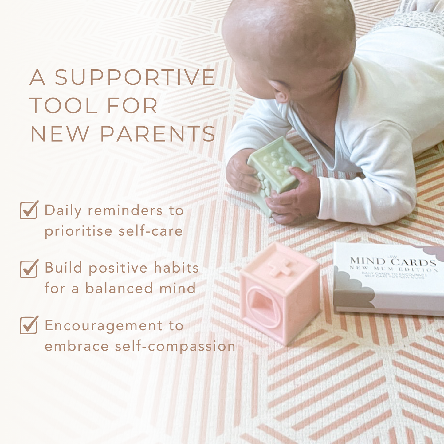 Baby holding a card with text about a supportive tool for new parents on a patterned surface.