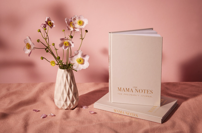 Book titled 'MAMA NOTES' with a vase of flowers on a pink background