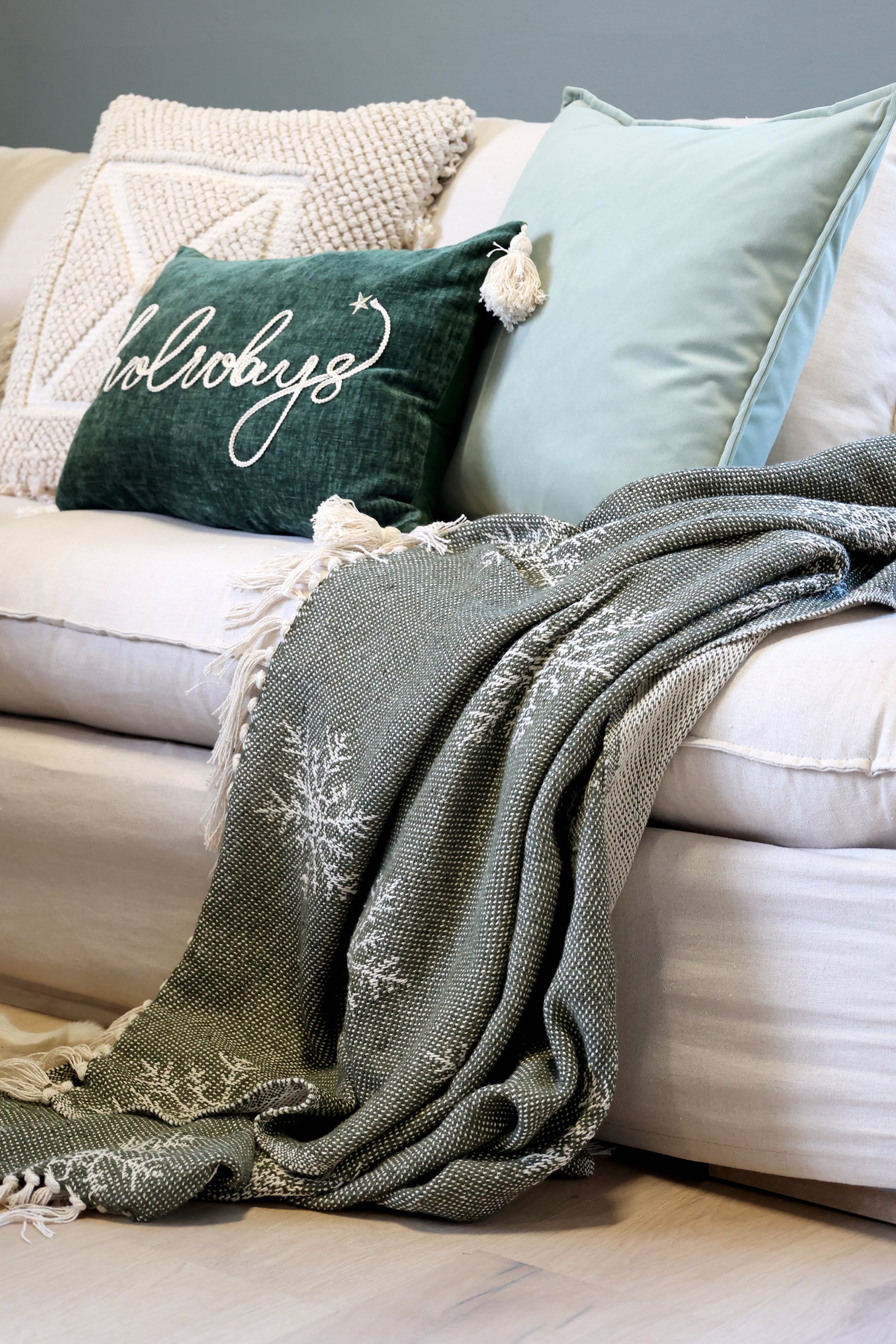 Cozy living room scene with a blanket and pillows on a sofa