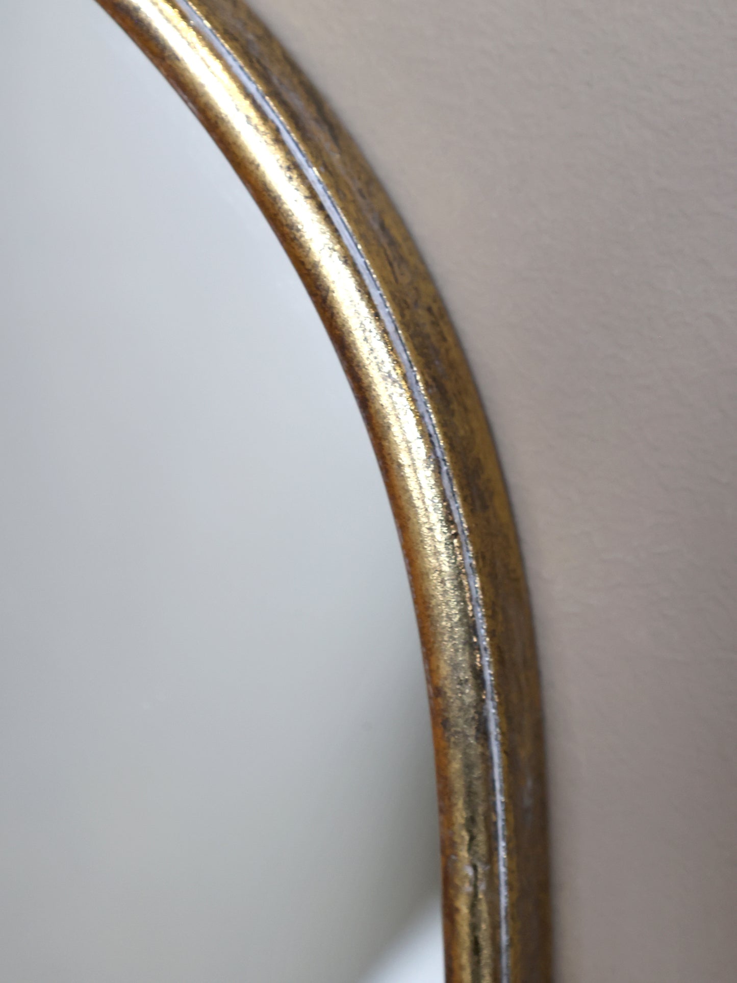 Close-up of a curved metallic object on a light gray background