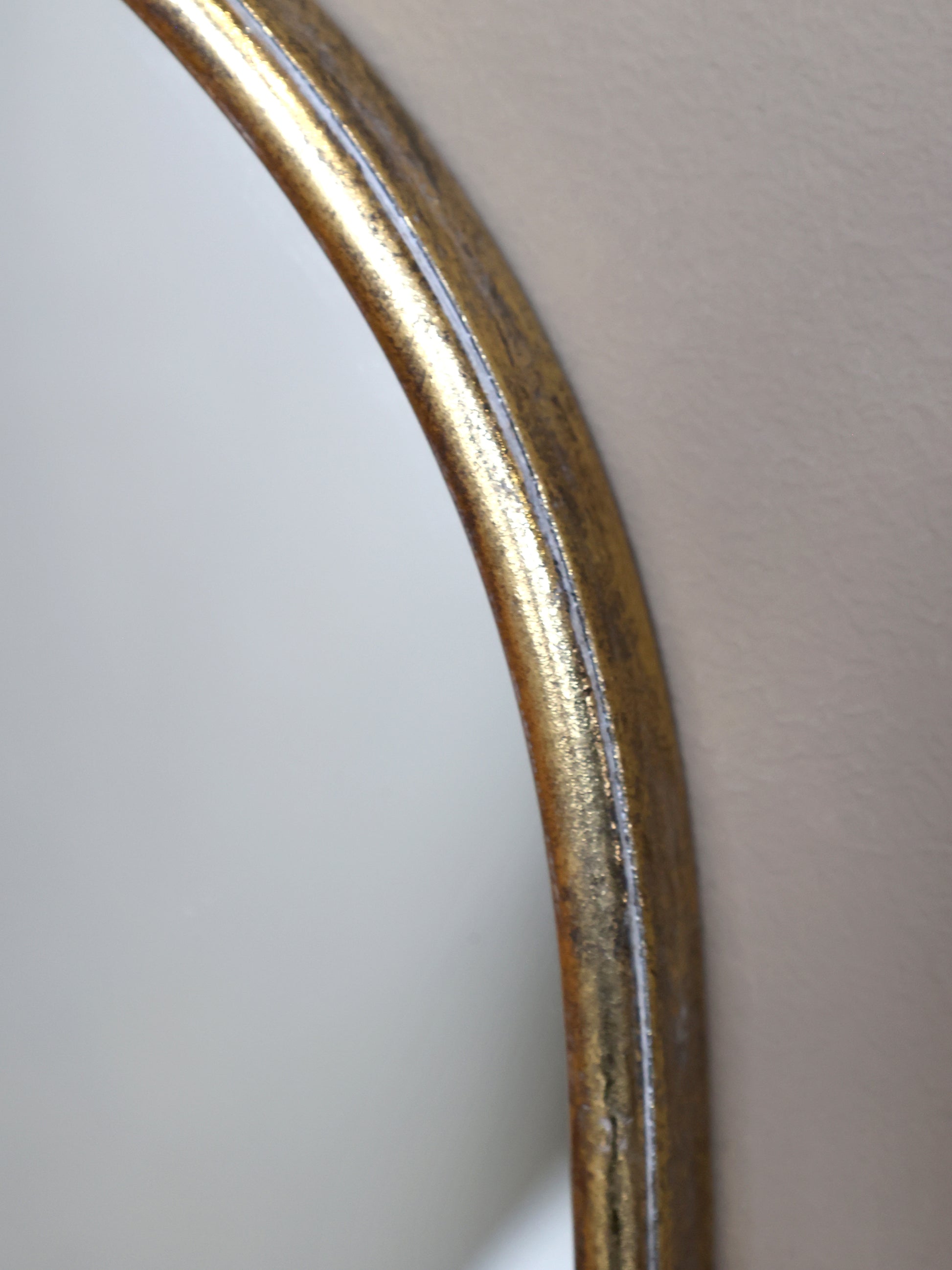 Close-up of a curved metallic object on a light gray background