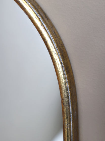 Close-up of a curved metallic object on a light gray background