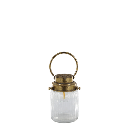 Clear glass lantern with brass lid and handle on a white background