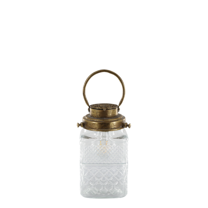 Clear glass lantern with a brass lid on a white background