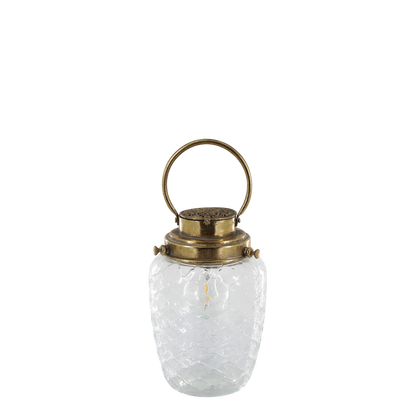 Clear glass lantern with brass handle and lid on a white background