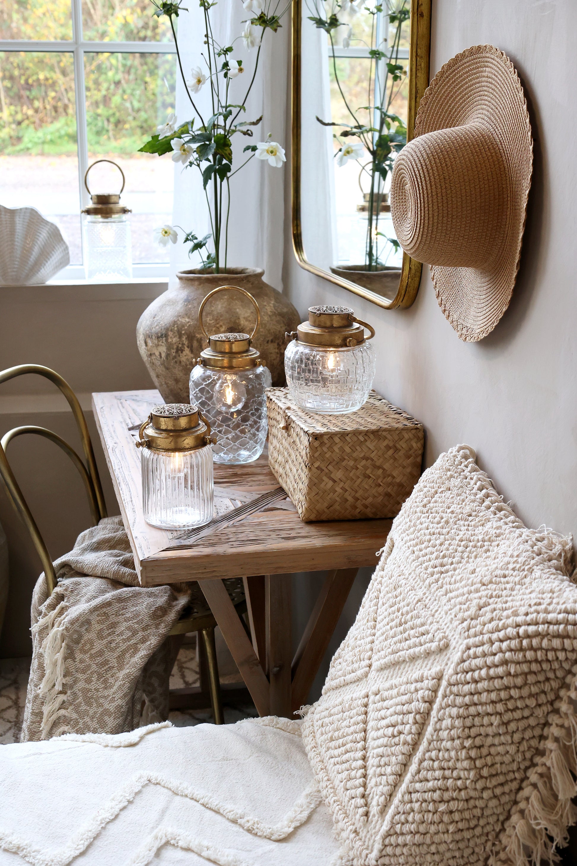 Cozy living room with wooden table, candles, and decorative items.