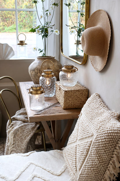 Cozy living room with wooden table, candles, and decorative items.
