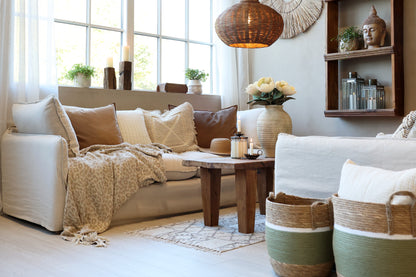 Cozy living room with beige sofa, wooden coffee table, and decorative items.