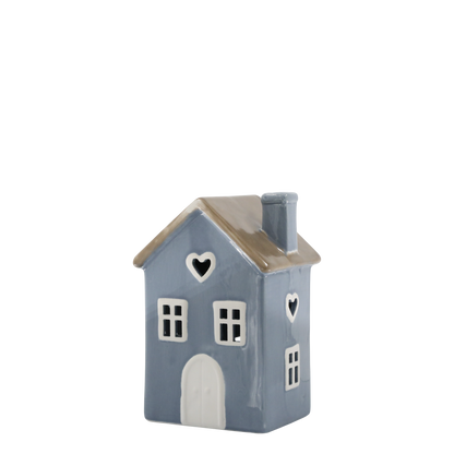 Ceramic house-shaped vase with a heart design on a white background