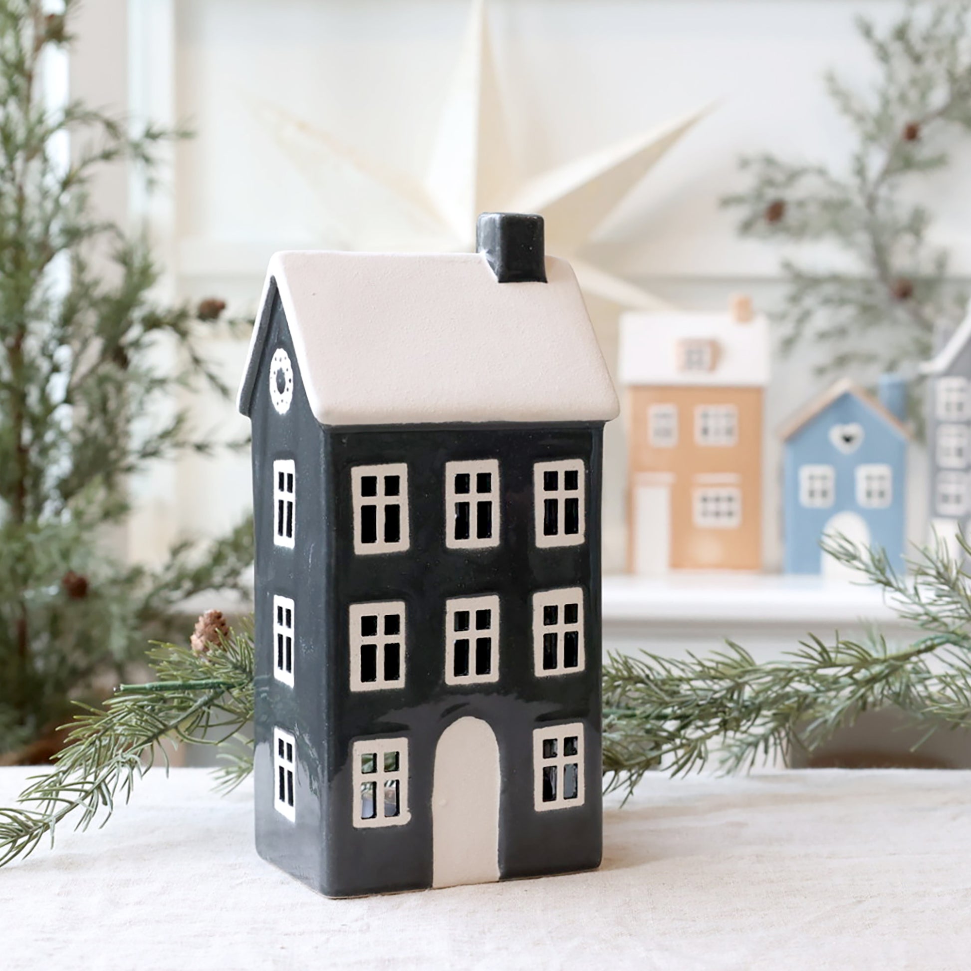 Decorative house-shaped lantern with a snowy background