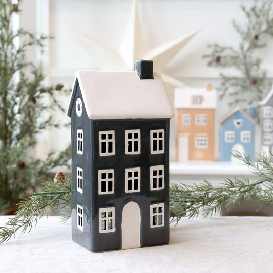 Decorative house-shaped lantern with a snowy background