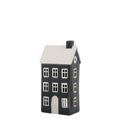 Black and white house-shaped ceramic lantern on a white background