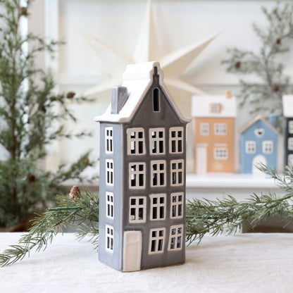 Decorative house-shaped lantern with a snowy background