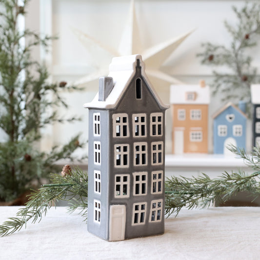 Decorative house-shaped lantern with a snowy background