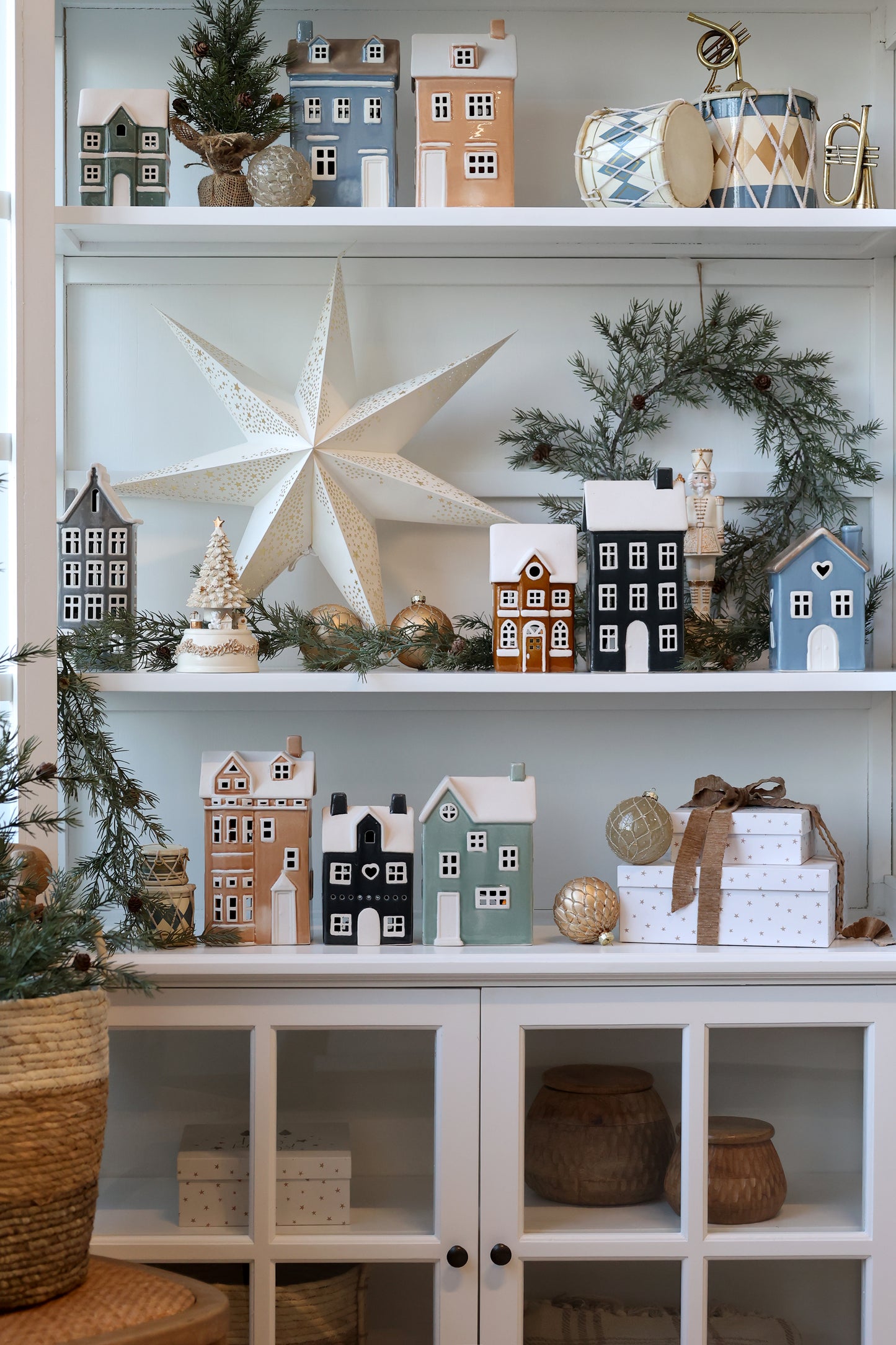 Decorative shelves with small model houses, a large star, and other ornaments.