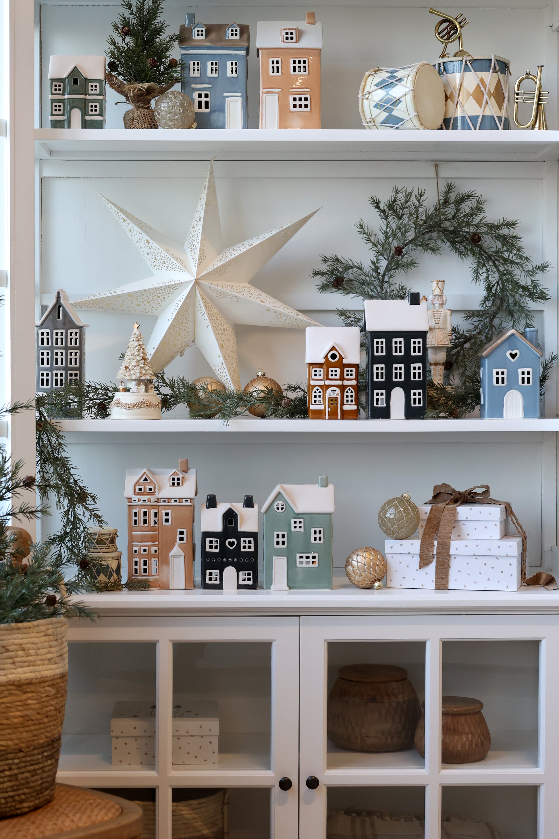Decorative shelves with small model houses, a large star, and other ornaments.