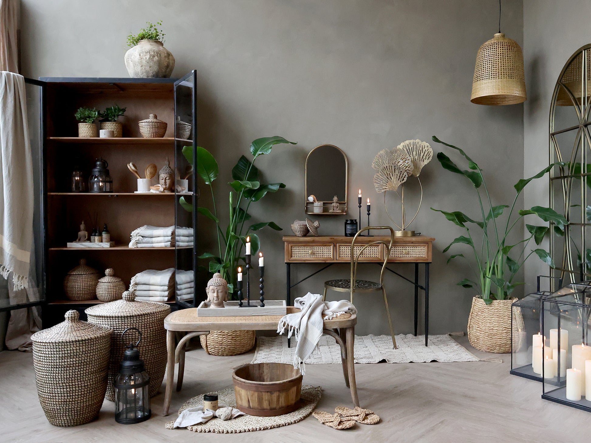 Living room with wooden furniture, plants, and decorative items against a gray wall.