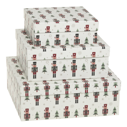 Set of three decorative boxes with nutcracker and Christmas tree pattern on a white background