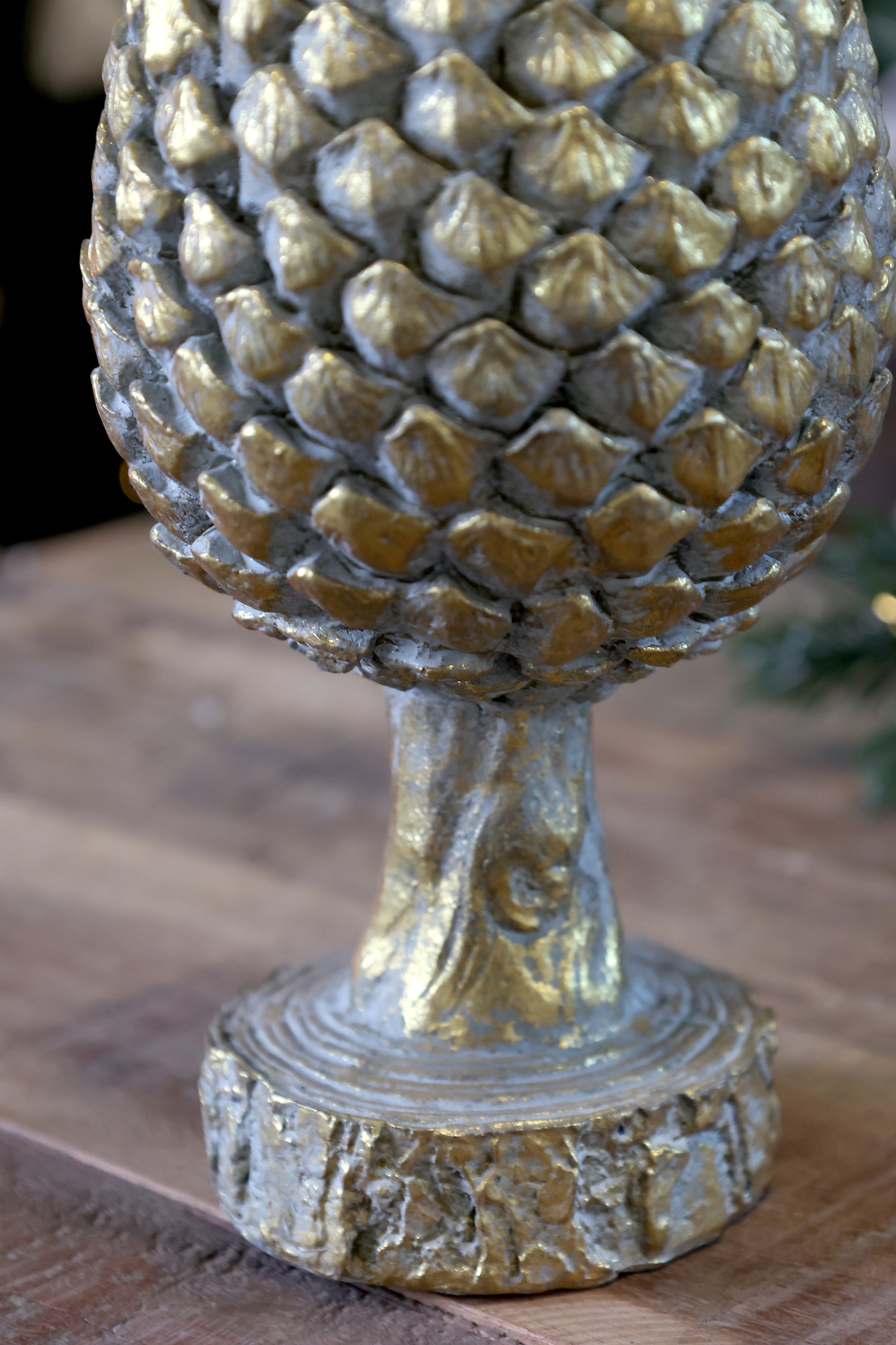 Decorative pineapple sculpture on a wooden surface