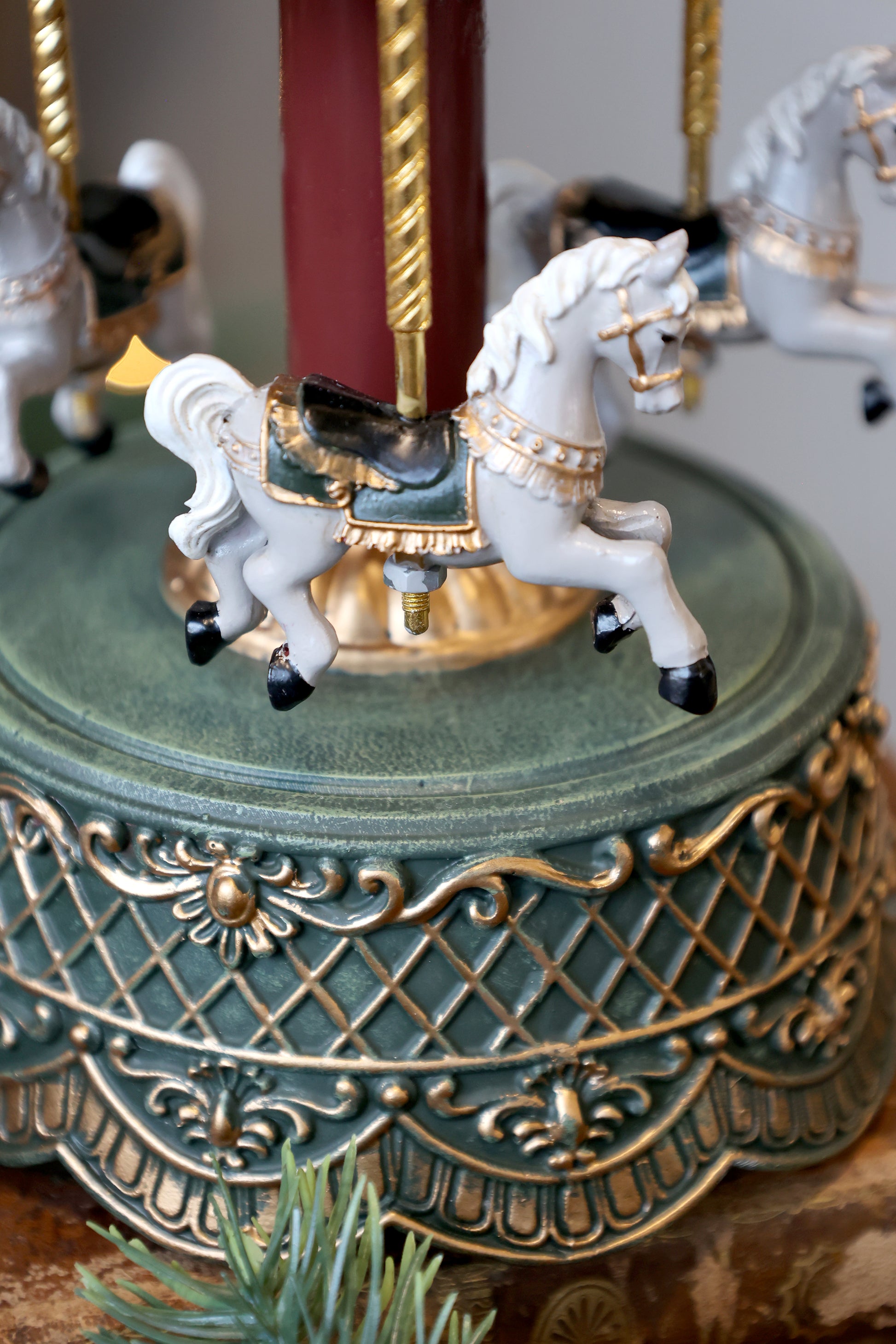 Decorative carousel with horses on a ornate base