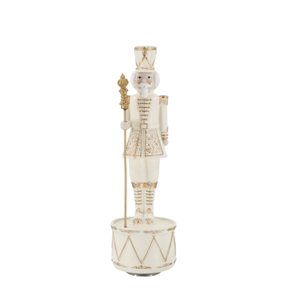 Decorative nutcracker figure with a drum on a white background