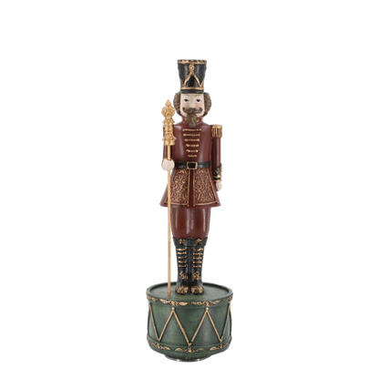 Decorative figurine of a soldier on a drum with a white background