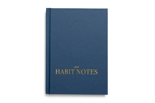 Blue notebook titled 'Habit Notes' with gold text on a white background