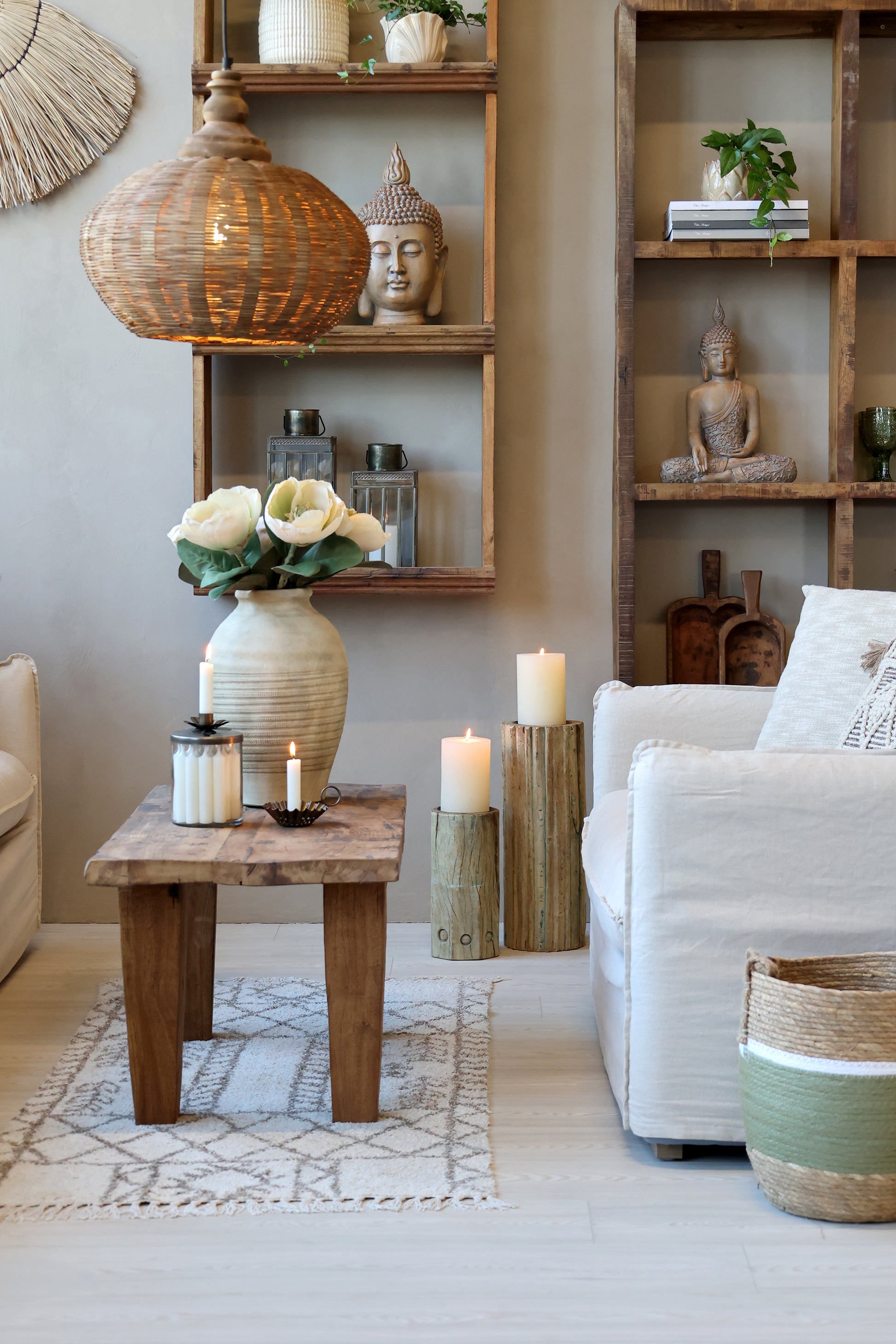 Living room with wooden shelves, white armchair, and decorative items.