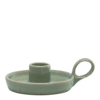 Green ceramic candle holder with handle on a white background