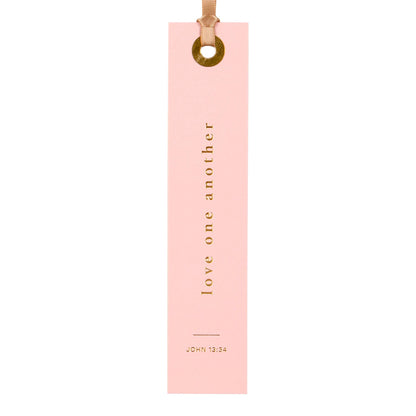 Pink bookmark with 'Love one another' text on a white background