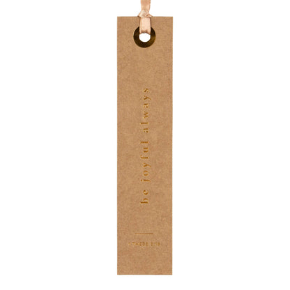 Kraft paper bookmark with 'be joyful always' text on a white background