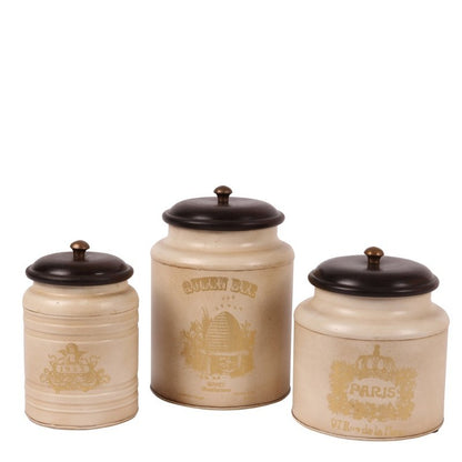 This stylish canister is perfect for storing items in the home or office. Crafted with a metal body, it has a unique Baroque-style pattern and a wood top. It measures 19x13cm and makes a beautiful statement in any room.  This baroque style iron canister with wooden lid is perfect to use as a storage jar for tea, coffee, sugar or as decoration in any other room of the house.  Antique Cream  Dimensions: h.19 x 13 cm. - Generosa