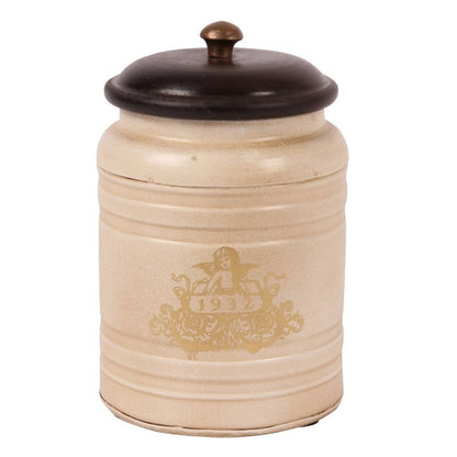 This stylish canister is perfect for storing items in the home or office. Crafted with a metal body, it has a unique Baroque-style pattern and a wood top. It measures 19x13cm and makes a beautiful statement in any room.  This baroque style iron canister with wooden lid is perfect to use as a storage jar for tea, coffee, sugar or as decoration in any other room of the house.  Antique Cream  Dimensions: h.19 x 13 cm. - Generosa