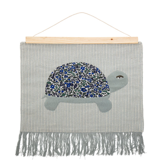 Turtle wall hanging made of 100% Cotton with wood hanger and rope.The wall decór is made of cotton . This lovely turtle wall hanging brings nature into your childs room.  Material: 100% cotton and wood hanger   Dimensions: L70xH67 cm